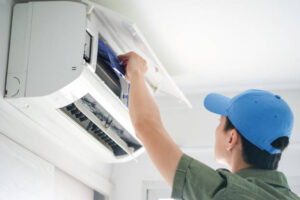 Male repair air conditioner at the room, He is air technician, mechanic, engineer. Maintenance air conditioner myself.soft focus